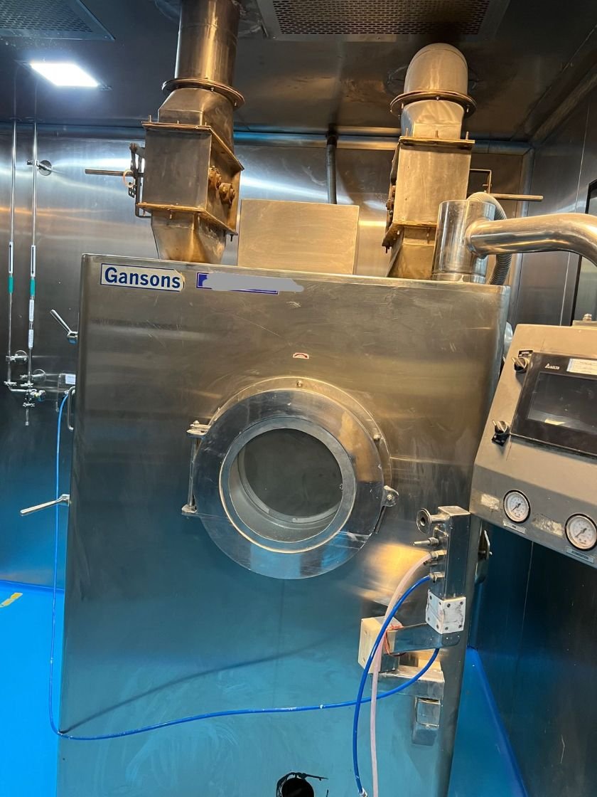 Pharma Unit for Sale in Paonta Sahib, Himachal Pradesh – ₹4 Cr Automatic tablet coating machine with twin inlet and exhaust ducts in the coating room of the pharmaceutical plant for sale in Paonta Sahib