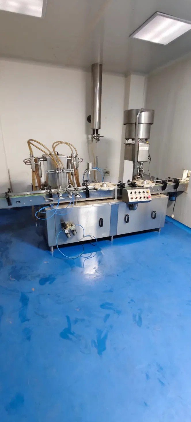 Pharma Unit for Sale in Paonta Sahib, Himachal Pradesh – ₹4 Cr Automatic bottle filling and capping line with conveyor in the liquid filling and sealing area of the Paonta Sahib pharma plant