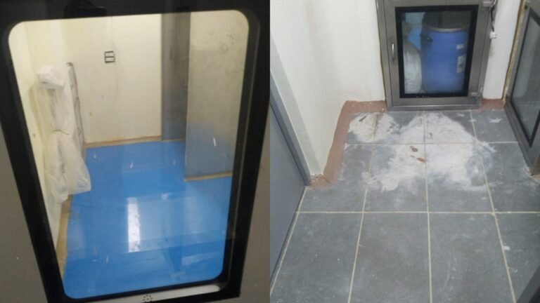 Airlock and change-room area at the Sansarpur Terrace pharma plant during epoxy flooring application, with pass box and flush doors