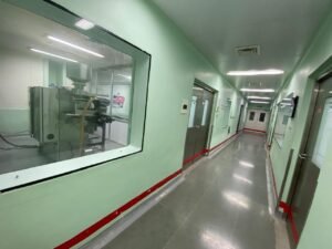 Production corridor with viewing window into packing room at tablet and liquid oral pharma plant for sale in kolhapur