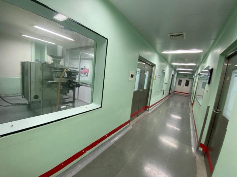 Production corridor with viewing window into packing room at tablet and liquid oral pharma plant for sale in kolhapur